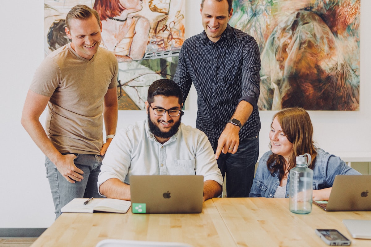 A small team around a laptop